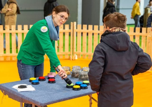 animateur fait deviner le son des animaux de la ferme à un enfant