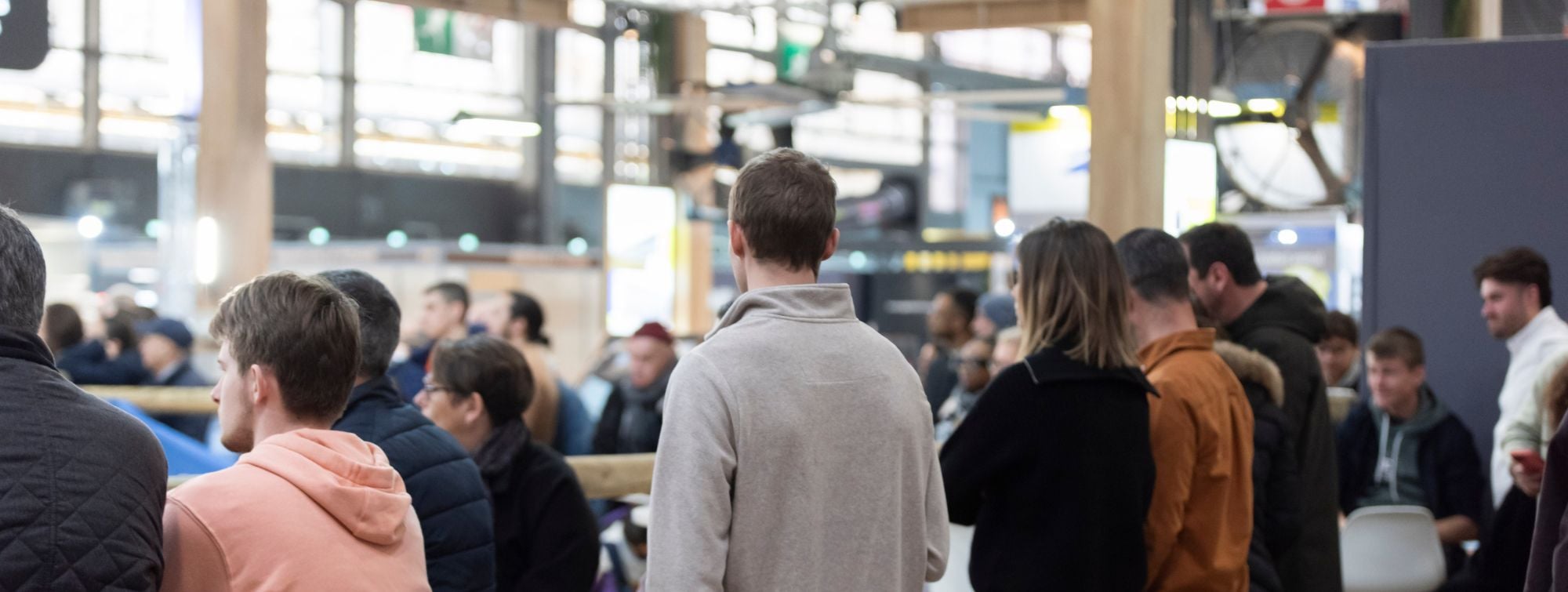 Visitors at SIA PRO 2026 gathered in an exhibition hall watching an activity at a demonstration area.